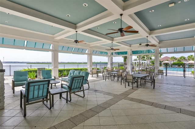 exterior space featuring a water view, ceiling fan, and a community pool