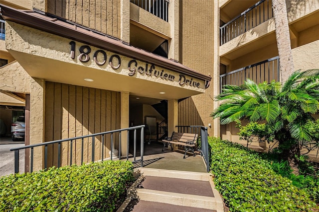 view of exterior entry featuring a balcony