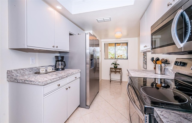 kitchen with stainless steel appliances and white cabinets