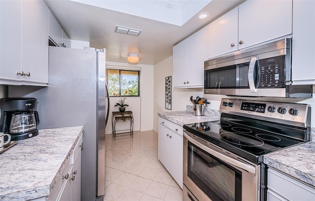 kitchen featuring appliances with stainless steel finishes and white cabinets