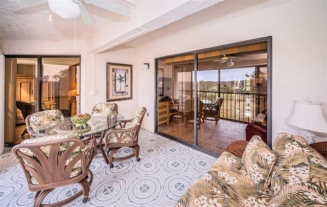 sunroom featuring ceiling fan