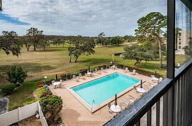 view of pool with a patio and a yard