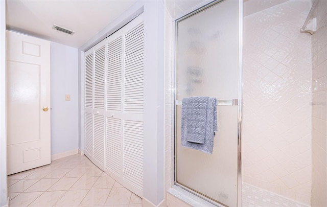 bathroom with tile patterned floors and an enclosed shower