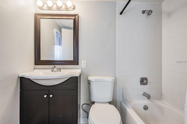 full bathroom featuring vanity, tiled shower / bath combo, and toilet