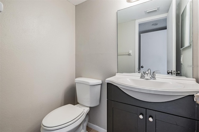 bathroom with toilet and vanity