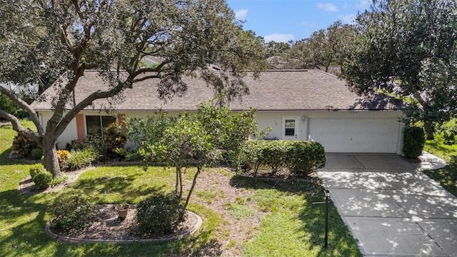 ranch-style house featuring a garage and a front lawn