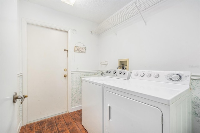 laundry room with washer and clothes dryer, dark hardwood / wood-style flooring, and a textured ceiling