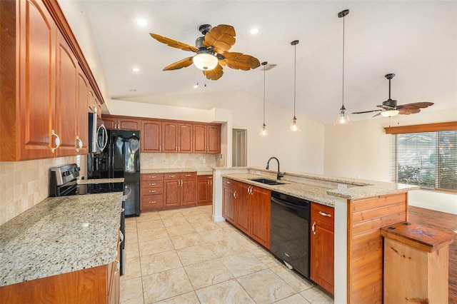 kitchen with a center island with sink, sink, and black appliances