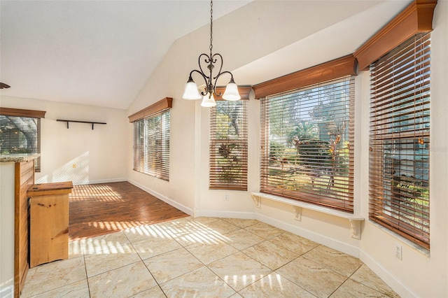 unfurnished dining area featuring vaulted ceiling, a chandelier, and light tile patterned floors