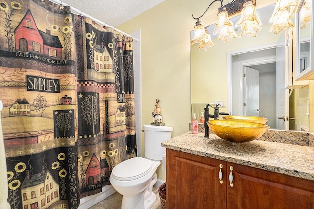 bathroom with toilet, tile patterned floors, vanity, and a textured ceiling