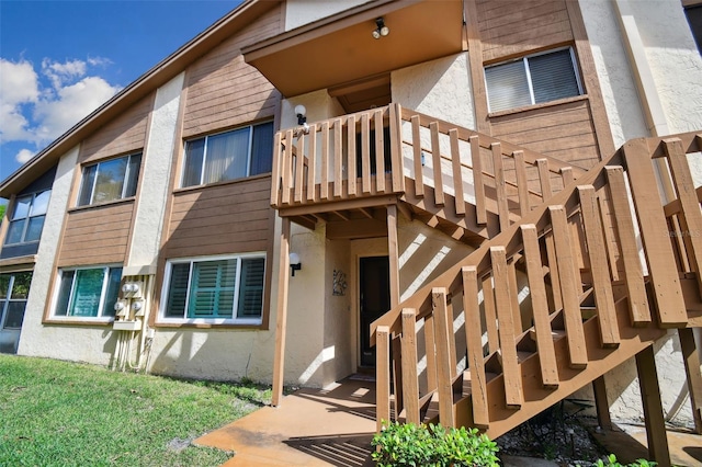 4028 Davit Dr Unit 4028, New Port Richey, FL 34652 - view of exterior entry featuring stucco siding and a balcony