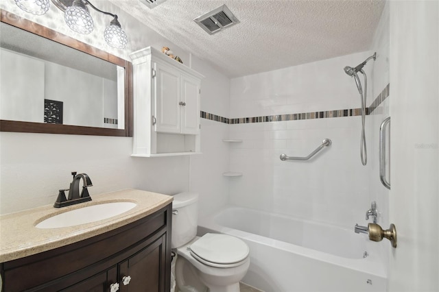 full bathroom featuring vanity, toilet, tiled shower / bath combo, and a textured ceiling