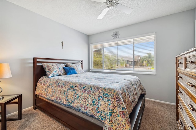 carpeted bedroom with multiple windows, a textured ceiling, and ceiling fan