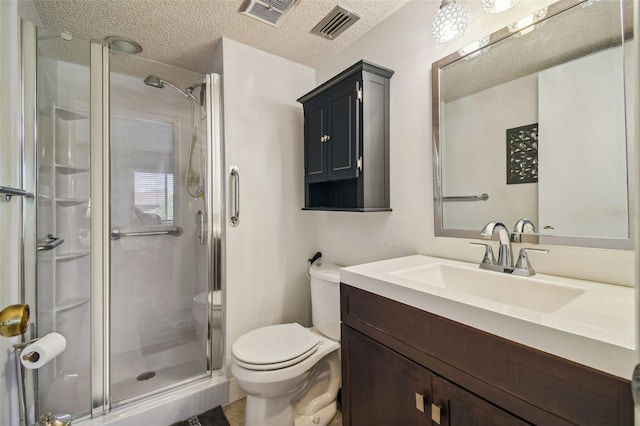 bathroom with toilet, a textured ceiling, a shower with shower door, and vanity