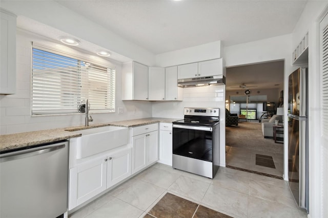 kitchen featuring sink, appliances with stainless steel finishes, decorative backsplash, and white cabinetry