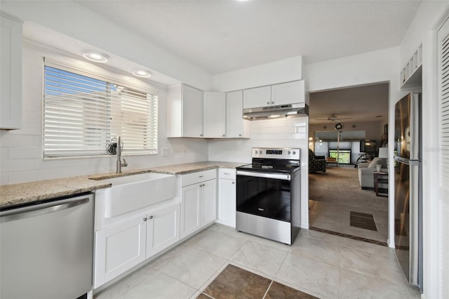 4028 Davit Dr Unit 4028, New Port Richey, FL 34652 - kitchen with appliances with stainless steel finishes, under cabinet range hood, white cabinetry, and light stone countertops