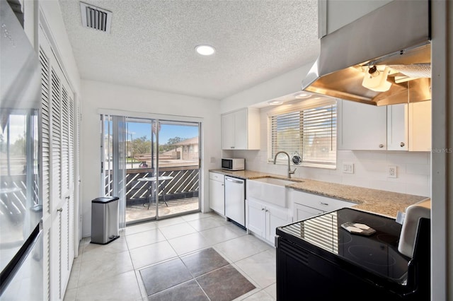 4028 Davit Dr Unit 4028, New Port Richey, FL 34652 - kitchen featuring black electric range oven, white microwave, stainless steel dishwasher, a textured ceiling, and white cabinetry