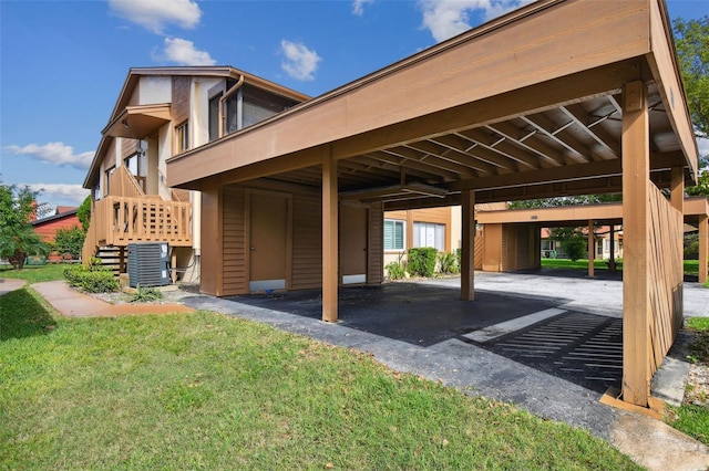 view of parking featuring a lawn and a carport