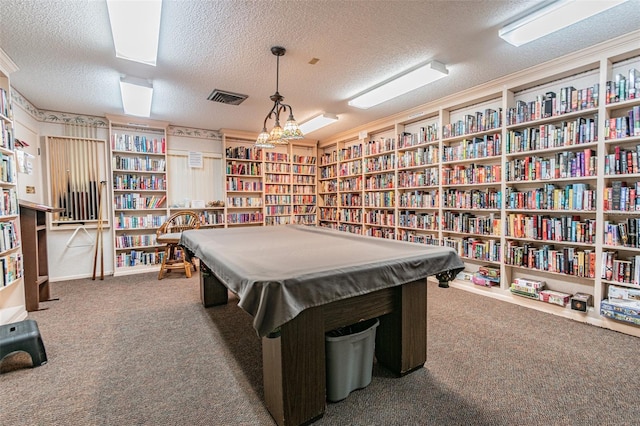 recreation room with a textured ceiling and carpet floors