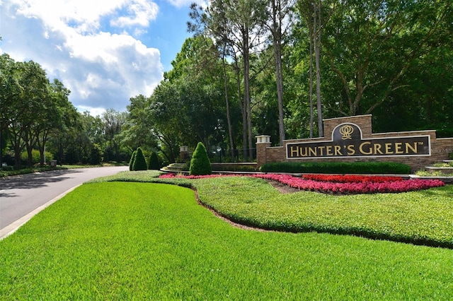 community sign featuring a lawn