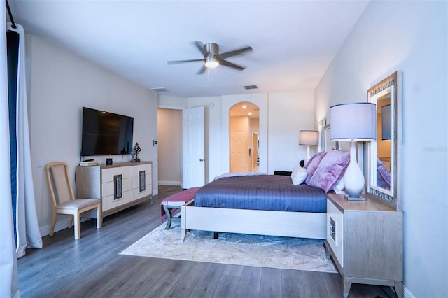 bedroom with dark hardwood / wood-style flooring and ceiling fan