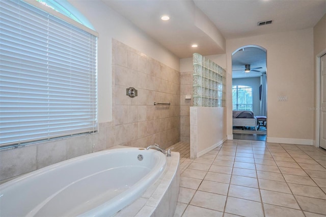 bathroom with ceiling fan, shower with separate bathtub, and tile patterned flooring