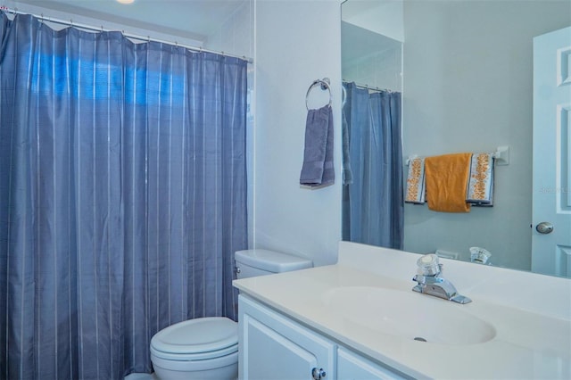 bathroom with vanity, curtained shower, and toilet