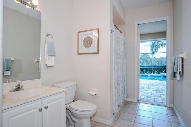 bathroom with vanity, tile patterned flooring, and toilet