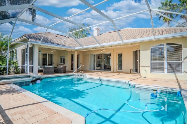 view of swimming pool with an outdoor living space, a patio area, ceiling fan, and glass enclosure