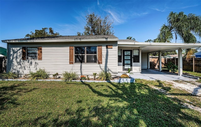 view of front of home with a front lawn and a carport