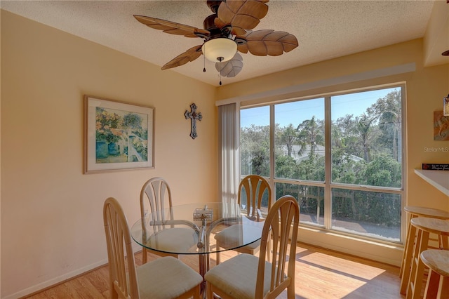 dining area with a healthy amount of sunlight, light wood-type flooring, and ceiling fan