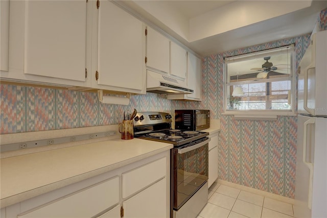 kitchen with white cabinetry, ceiling fan, stainless steel electric range, light tile patterned floors, and white refrigerator