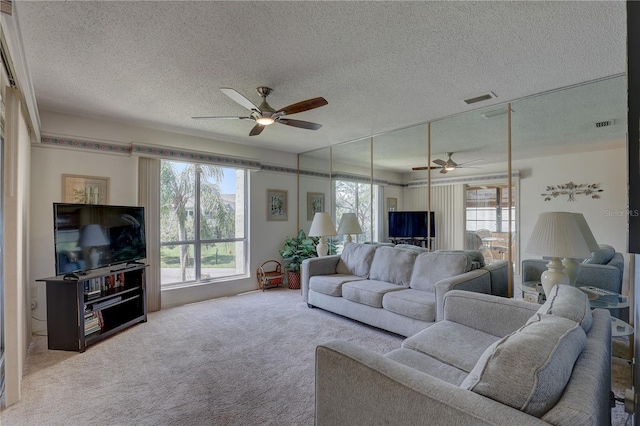 living room featuring a textured ceiling, light colored carpet, and ceiling fan