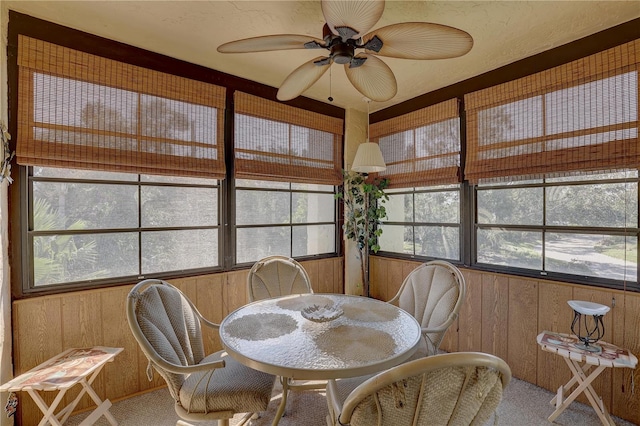 sunroom / solarium featuring ceiling fan