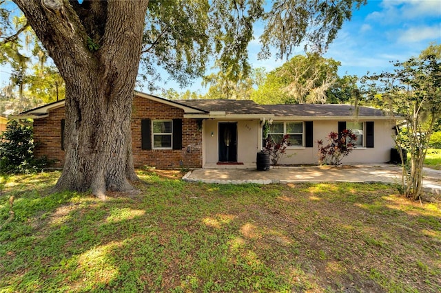 single story home featuring a patio area and a front lawn