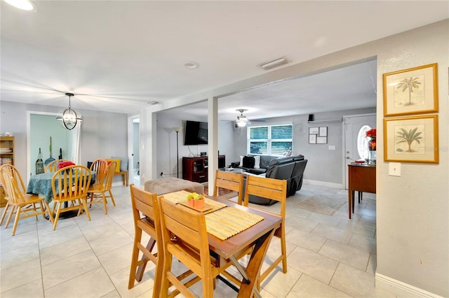 dining room featuring ceiling fan with notable chandelier