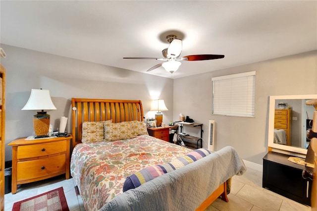 tiled bedroom featuring ceiling fan