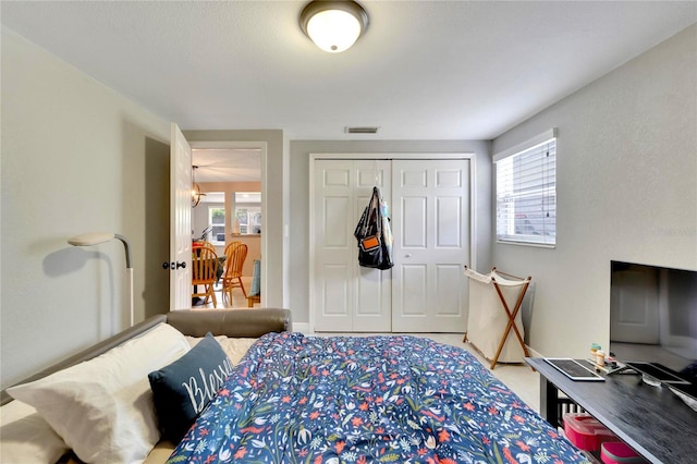 bedroom with a closet and multiple windows