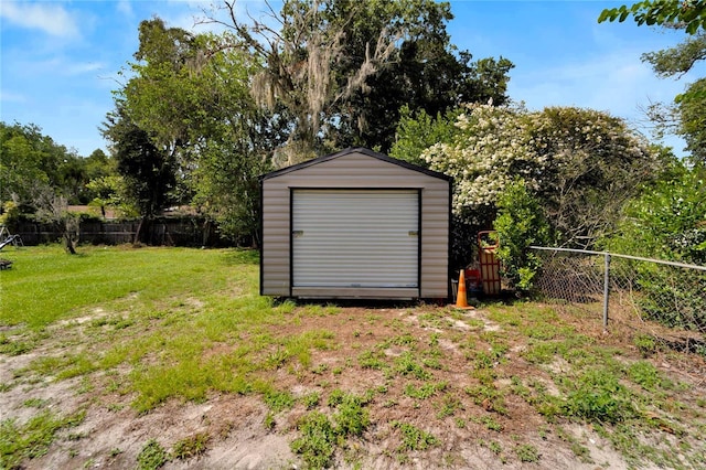 view of outbuilding featuring a lawn