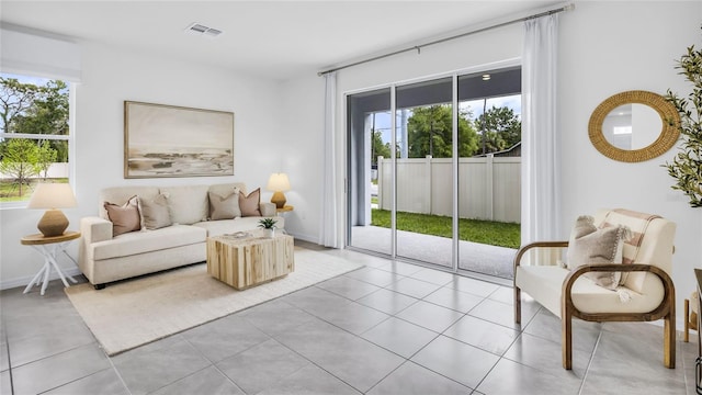 tiled living room featuring a healthy amount of sunlight