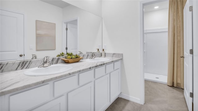 bathroom with tile patterned floors and vanity