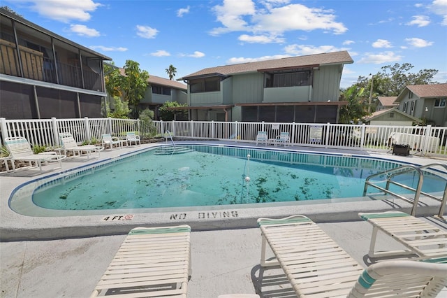 view of pool with a sunroom