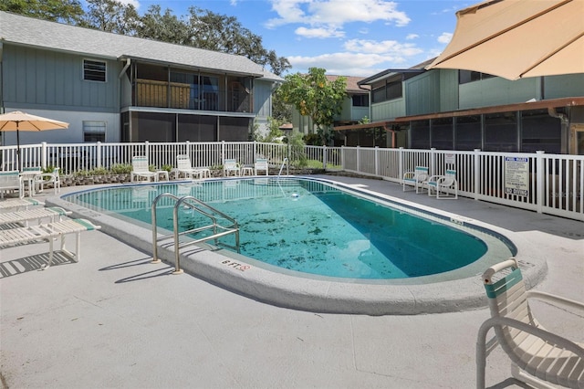 view of pool featuring a patio and a sunroom