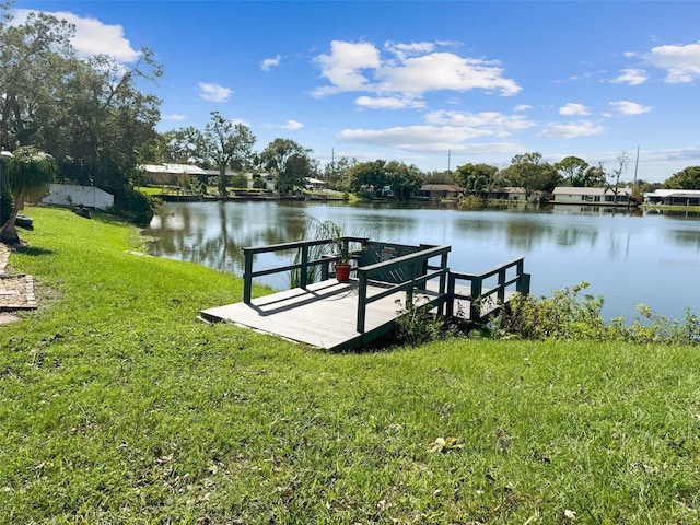 dock area featuring a water view and a yard