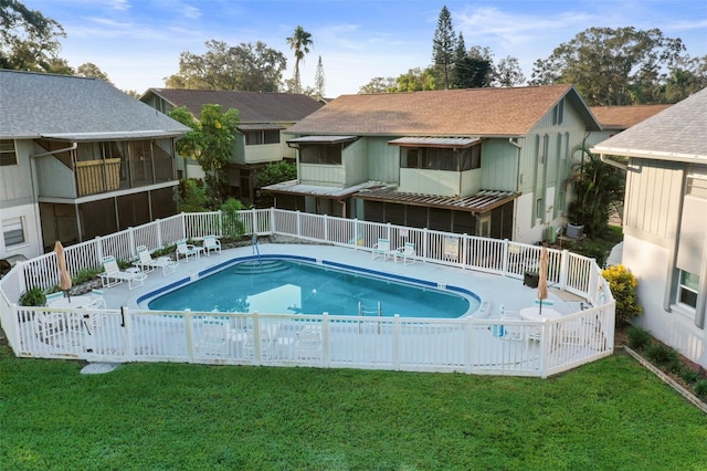 view of pool with a lawn