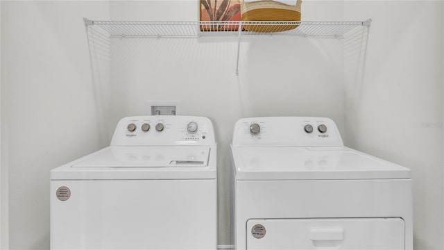 clothes washing area featuring washer and clothes dryer