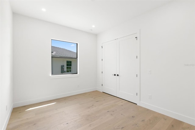 1810 4th St E, Palmetto, FL 34221 - unfurnished bedroom with baseboards, light wood finished floors, recessed lighting, and a closet