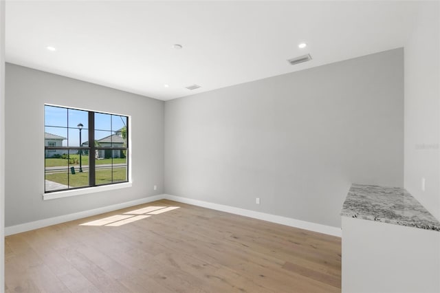 unfurnished room featuring light hardwood / wood-style floors