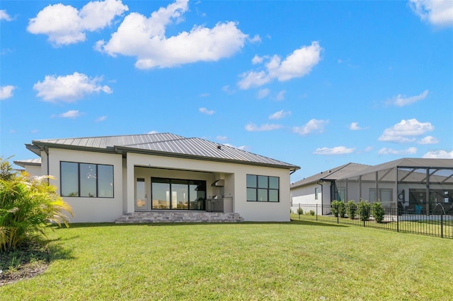 rear view of house featuring a lawn and a lanai