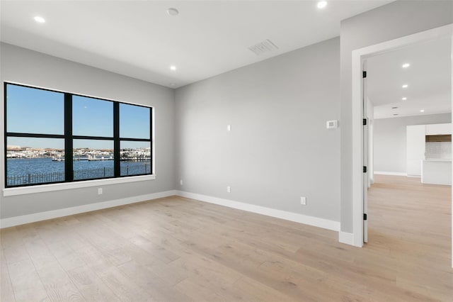 1810 4th St E, Palmetto, FL 34221 - unfurnished room with light wood-type flooring, recessed lighting, and baseboards
